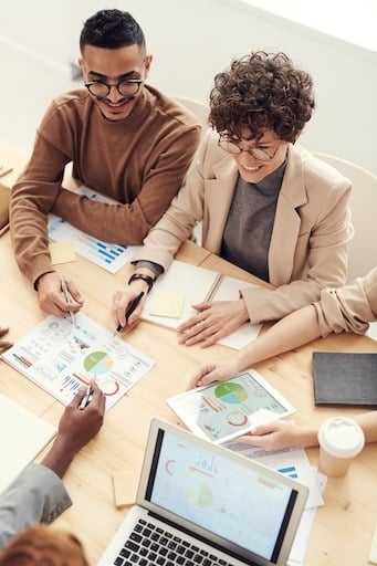 People at a board table discussing UI